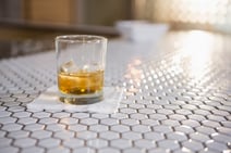 Glass of whisky on bar counter in bar